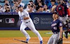 The Dodgers’ Max Muncy (and Twins pitcher Joe Ryan and catcher Sandy Leon) followed the flight of the ball after Muncy belted a home run in the thir