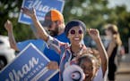 U.S. Rep. Ilhan Omar waves to passersby for support during a voter engagement event on the corner of Broadway and Central Avenues in Minneapolis on Tu