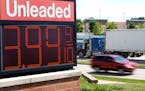 The price of regular unleaded gas is advertised for just under $4 a gallon in Menomonie Falls, Wis. 