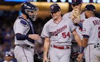 Minnesota Twins starting pitcher Sonny Gray, second from left, stands on the mound with catcher Gary Sanchez, left, Carlos Correa, second from right, 