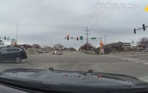 A still from squad car footage shows a St. Cloud driver driving through a red light and getting hit by a semi on Sunday, April 25, 2021. The squad car