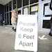A sign asks those getting vaccinated to keep 6 feet apart during the vaccination event, Wednesday, Jan. 27, 2021, at Nevada Union High School in Grass