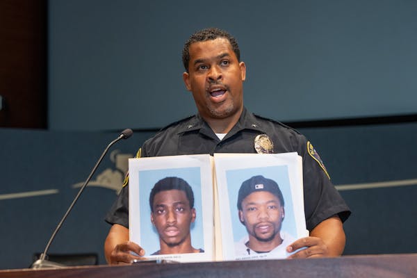 At a news conference Bloomington Police Chief Booker Hodges held up photos of Shamar Alon Ramon Lark, left, and Rashad Jamal May, sought in connection