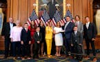 House Speaker Nancy Pelosi of Calif., center, conducts a ceremonial swearing-in for Rep. Brad Finstad, R-Minn., fourth from right, joined by his wife 