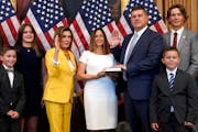 Rep. Brad Finstad, R-Minn., was joined by wife Jaclyn, center, and their family on he was sworn in by House Speaker Nancy Pelosi on Friday in Washingt