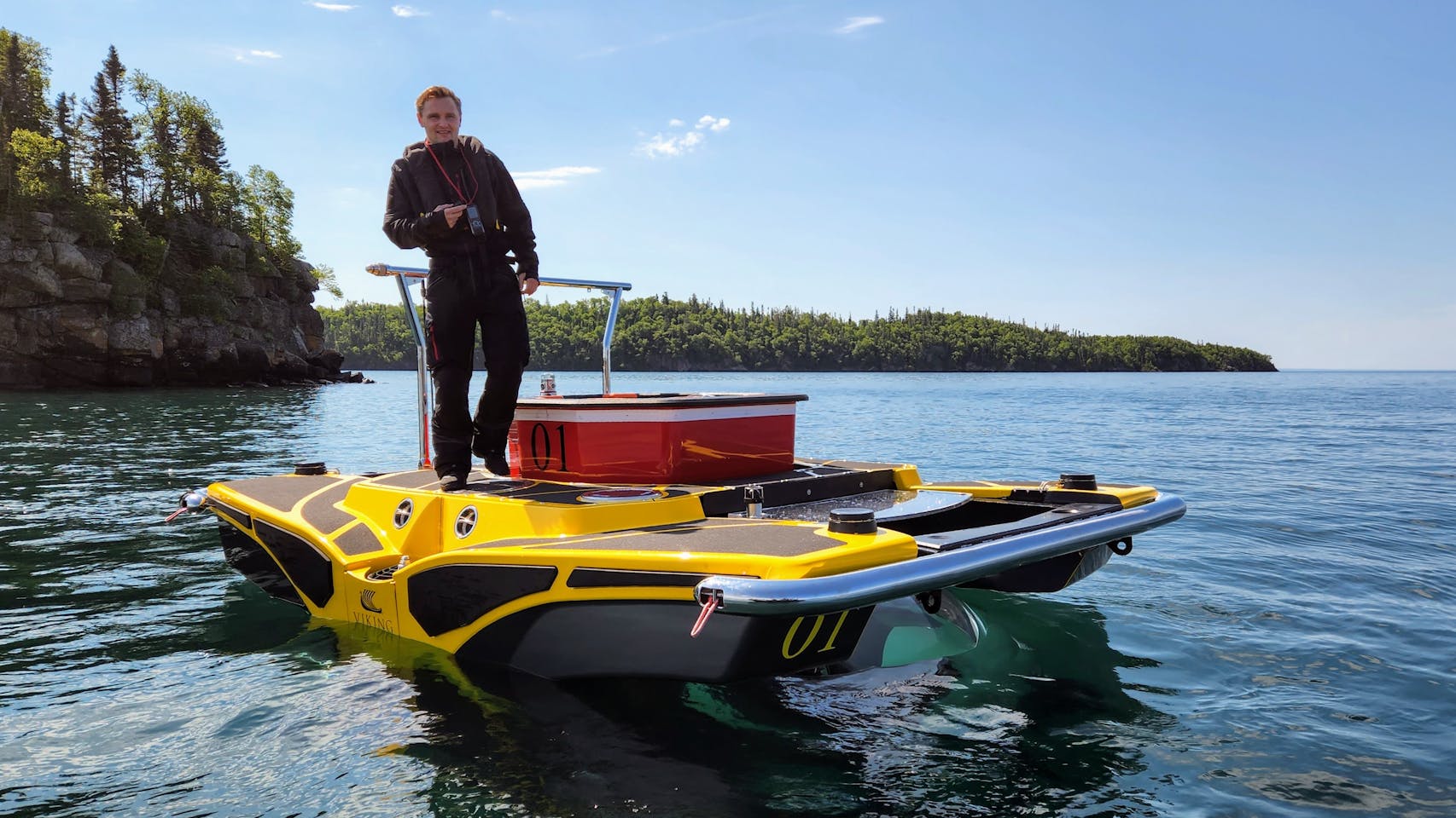 A Viking submarine pilot waited for passengers to come aboard, next to tiny Pyritic Island in Lake Superior.
