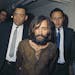 In this 1969 file photo, Charles Manson is escorted to his arraignment on conspiracy-murder charges in connection with the Sharon Tate murder case. Ma
