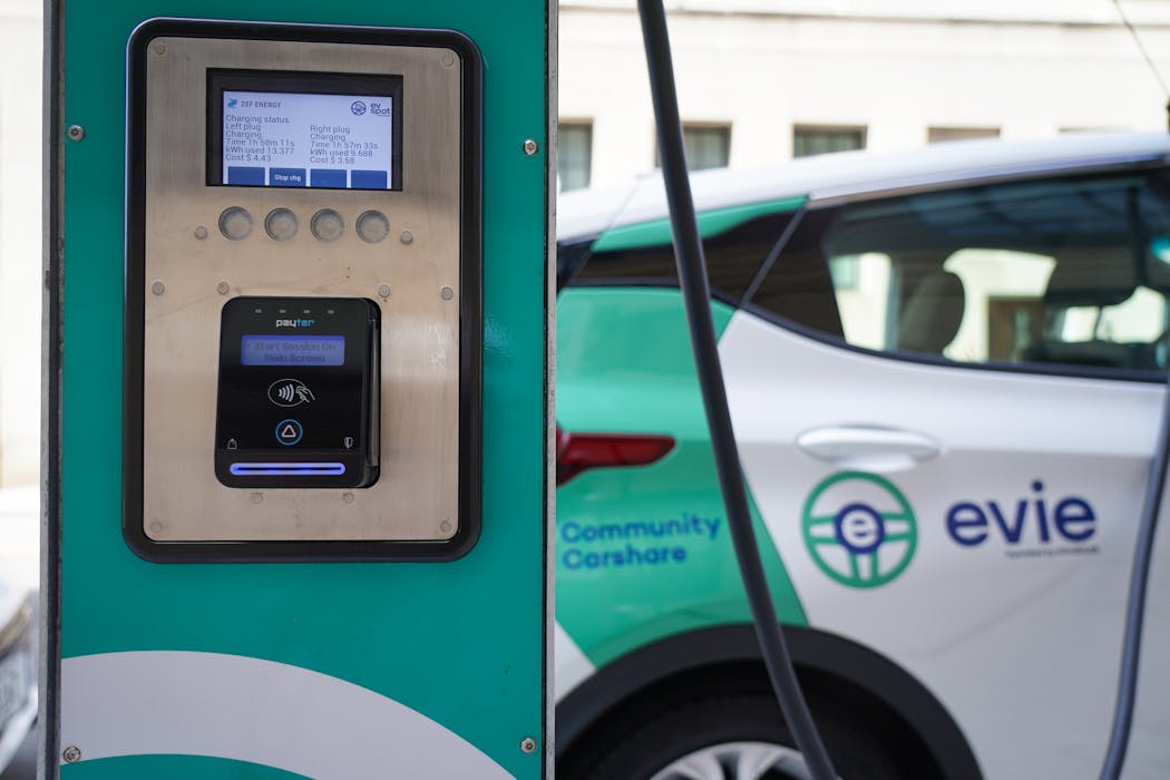 An Evie all-electric community rideshare vehicle recharges at a station in St. Paul.