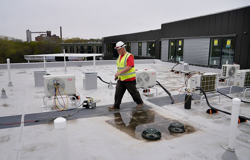 Pipe fitter Brian DeGidio, who works for Wenzel Heating and Air Conditioning in Eagan, helped install heat pumps, a climate-friendly HVAC system, on a St. Paul apartment building.