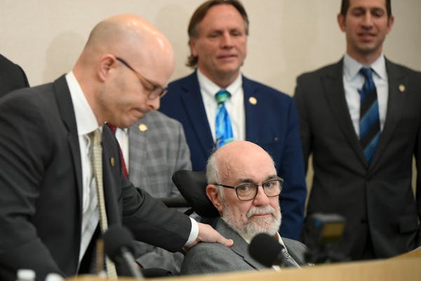 Rep. Dave Lislegard rubbed the shoulder of Sen. David Tomassoni during a news conference highlighting ALS legislation on March 1 at the Carpenters Loc