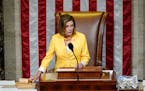 House Speaker Nancy Pelosi of Calif., finishes the vote to approve the Inflation Reduction Act in the House chamber at the Capitol in Washington, Frid