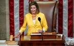 House Speaker Nancy Pelosi of Calif., finishes the vote to approve the Inflation Reduction Act in the House chamber at the Capitol in Washington, Frid