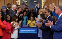 Speaker Nancy Pelosi (D-Calif.), center, and members of the U.S. House of Representatives celebratee during an enrollment ceremony for the Inflation R