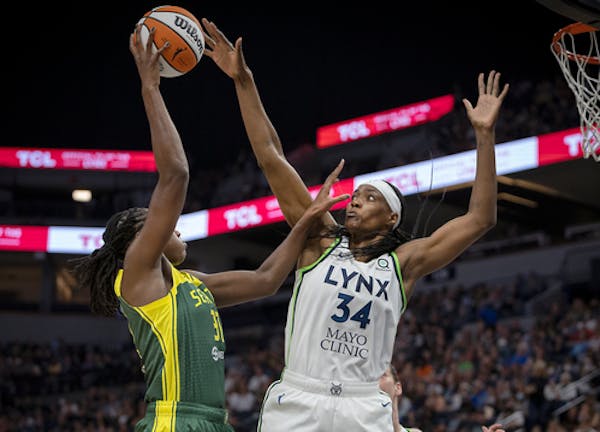 Minnesota Lynx center Sylvia Fowles (34) blocks a shot from Seattle Storm’s Tina Charles during the second quarter of a WNBA basketball game Friday,