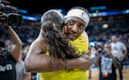 Lynx center Sylvia Fowles (34) hugs Seattle's guard Sue Bird (10) after the Lynx lost to the Seattle Storm 96-69.