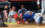 Angels center fielder Magneuris Sierra was tagged out at the plate by Twins catcher Gary Sanchez, trying to stretch a tying two-run triple into a walk