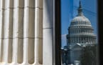 FILE — The US Capitol building is reflected in a window on in Washington on July 12, 2022. 