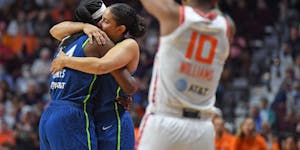 Lynx center Sylvia Fowles, left, embraced teammate Natalie Achonwa as Sun guard Courtney Williams applauded in the closing minute Sunday. Fowles playe