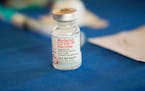 FILE - A vial of Moderna COVID-19 vaccine rests on a table at an inoculation station next to Jackson State University in Jackson, Miss., on July 19, 2