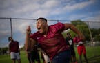 Lineman Myint Thu took part in a drill at the direction of defensive line coach Chris Oliva on the first day of football practice Monday afternoon at 