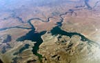 FILE - An aerial view of Lake Powell on the Colorado River is seen along the Arizona-Utah border on Sept. 11, 2019. Federal officials on Tuesday, Aug.