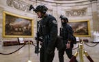 Members of the U.S. Secret Service Counter Assault Team walked through the Rotunda as police forces responded to the U.S. Capitol rio in Washington, J