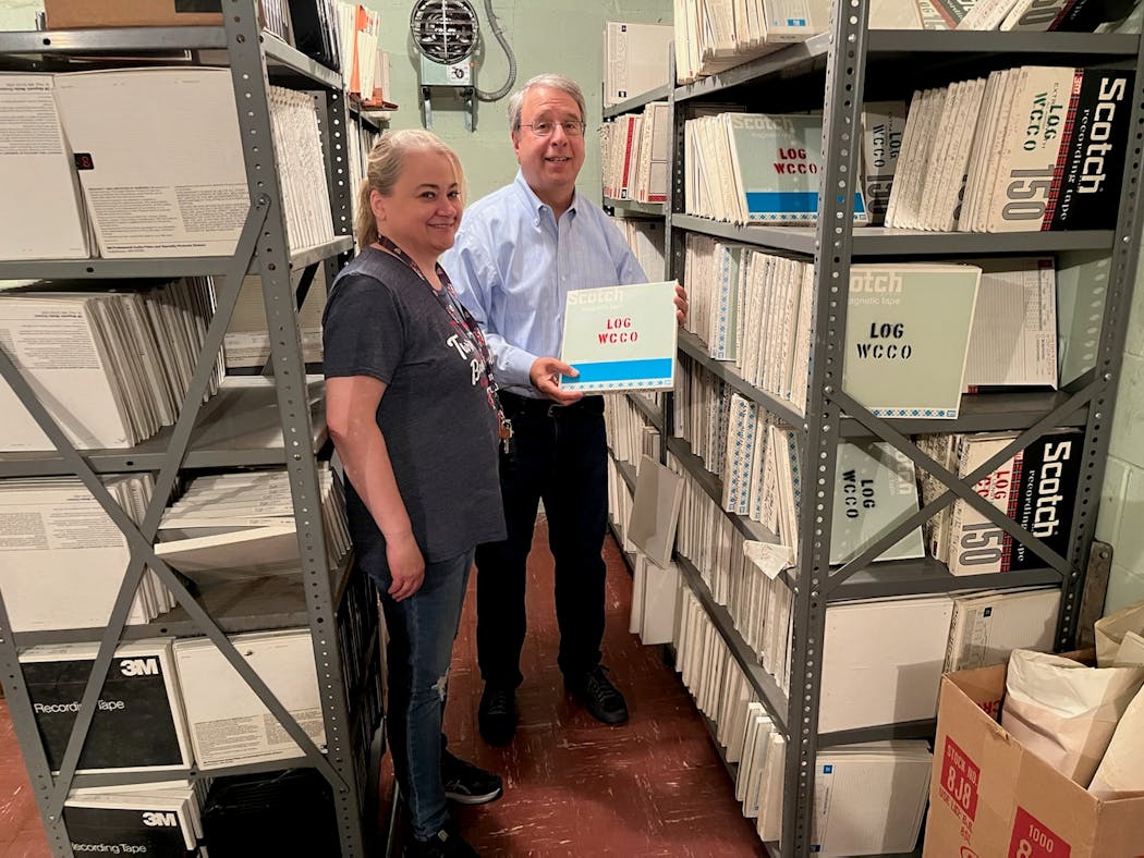 Meachael Schoenrock (left) and Tom Gavaras (right) stand amid a treasure trove of WCCO-AM reel-to-reel tapes.