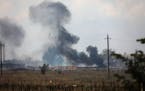 Smoke rises over the site of explosion at an ammunition storage of the Russian army near the village of Mayskoye, Crimea, Tuesday, Aug. 16, 2022.