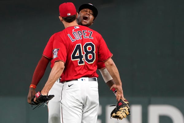 Twins reliever Jorge Lopez celebrated with first baseman Tim Beckham after the team’s 4-2 win over the Royals on Monday.