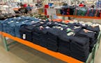 Shoppers peruse jeans on display in a Costco warehouse Monday, Aug. 15, 2022, in Sheridan, Colo.