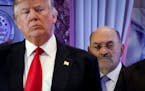FILE - Allen Weisselberg, right, stands behind then President-elect Donald Trump during a news conference in the lobby of Trump Tower in New York, Jan