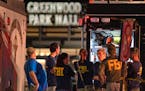 FBI agents gather at the scene of a deadly shooting, July 17, at the Greenwood Park Mall, in Greenwood, Ind. 