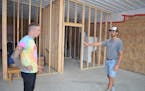 Mark Martincek, left, and Matthew Jewison talk about the layout of their future commercial kombucha brewery inside a building Jewison owns at 4181 31s