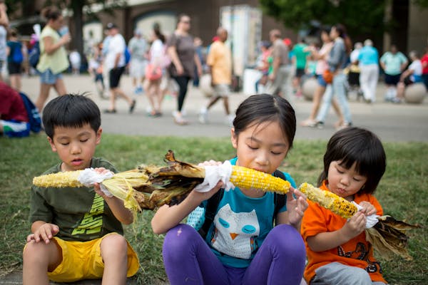 Kylie Yu, 9, center, chowed down on sweet corn ears with her younger brothers, Michael, 5, left, and Charlie, 3, at the Minnesota State Fair Thursday.