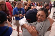 Olympic gold-medal gymnast Suni Lee hugged Mary Romoser, her grade school science teacher, at her alma mater, Battle Creek Elementary School, Thursday