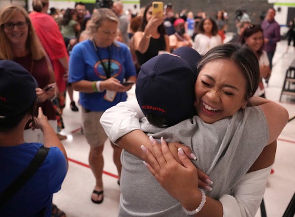 Olympic gold-medal gymnast Suni Lee hugged Mary Romoser, her grade school science teacher, at her alma mater, Battle Creek Elementary School, Thursday