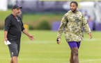 Injured tight end Irv Smith Jr., right, with tight ends coach Brian Angelichio at a Vikings practice last week.