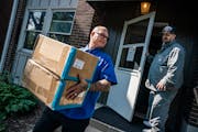 Hennepin County outreach worker Edward Weibye, who was homeless himself at one point, helps John Massicotte move into an apartment from a sober house 