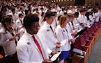 Medical student Nobles Antwi and his classmates recite an oath they wrote together during the University of Minnesota Medical School’s annual White 