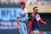 Twins pitcher Tyler Mahle exits the game with head athletic trainer Michael Salazar during the third inning Wednesday