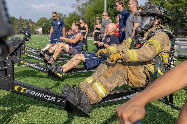 Saint Paul Firefighter Thomas Hilpisch took to the rowing machines in full gear as he joined other firefighters, EMS trainees, community members, and 