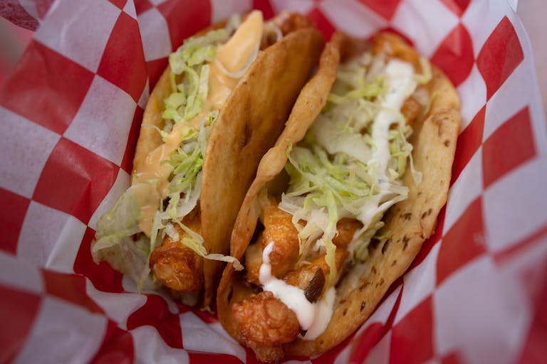 The Original Cheese Curd Taco and Box Checker Cheese Curd Taco from Richie’s Cheese Curd Tacos. New foods at the Minnesota State Fair photographed o