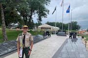 Dom Claseman at the Olivia veterans memorial he built for his Eagle Scout project.