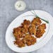 Serve tasty Corn and Zucchini Fritters with a Parmesan-Chive Dipping Sauce as a side or appetizer.