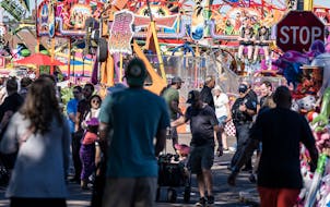 Fairgoers at the Minnesota State Fair on Sunday, Sept. 4, a day after a shooting near the entrance to the Midway left one person wounded.