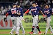 Minnesota Twins shortstop Carlos Correa (4) celebrates with teammates after the ninth inning of the team's baseball game against the New York Yankees 