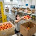 Archive photo of volunteer Janessa Rosenfield of Hopkins packed apples into boxes at Second Harvest Heartland in Brooklyn Park on Friday, May 22, 2020