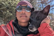 Emily Ford with her sled dog, Diggins, on a break during their journey on skis across the Boundary Waters Canoe Area Wilderness. 