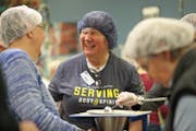 Volunteers gathered at the workstation tables at Feed My Starving Children in Coon Rapids.