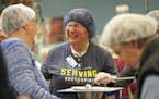 Volunteers gathered at the workstation tables at Feed My Starving Children in Coon Rapids.